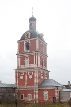 Red orthodox church with grey dome
