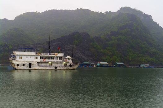 Ship at Anchor Before Dawn in Ha Long Bay, Vietnam.