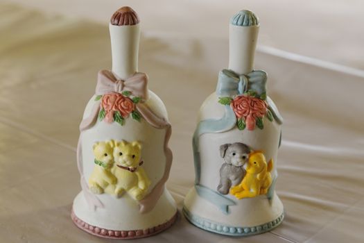 Cute and crafty ceramic bell in pink and blue. Cute teddy bear scene with flowers and ribbons.