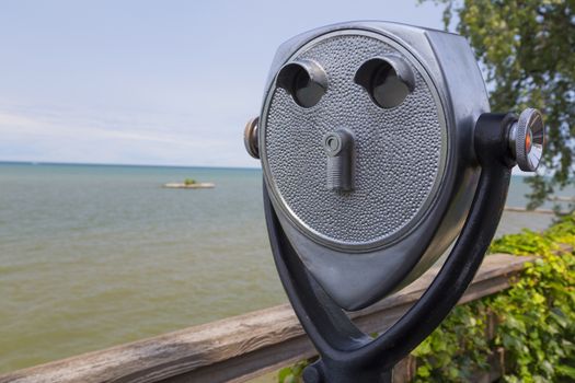 Quarter powered skyline viewer on a board walk overlooking Lake Ontario.