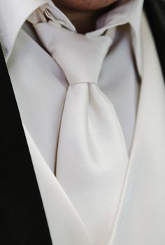 Cream colored shirt, vest, and tie of the groom. 