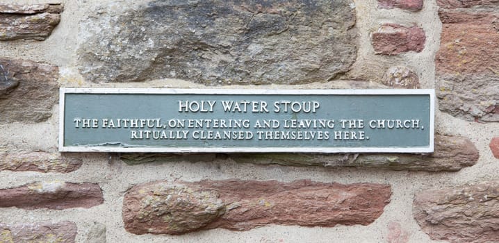 Sign at a holy water stoup at a ruin in Scotland