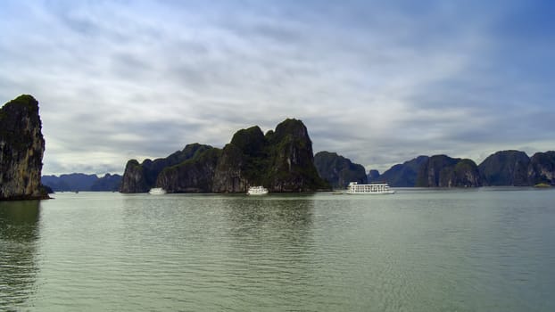 Three Ships and Rocks in Ha Long Bay, Vietnam.