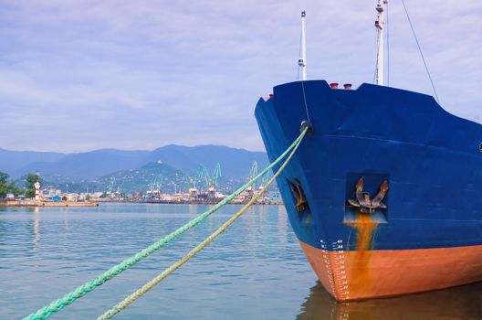 Ship fore with ropes attached to quay