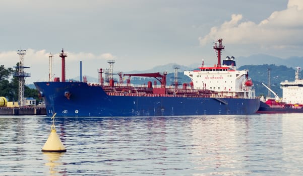 Tanker in port. Oil tanker in the proccess of unloading
