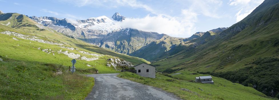 VILLE DES GLACIERS, FRANCE - AUGUST 27: Panoramic of chalets with Glacier Needles. The region is a stage at the Mont Blanc tour, which crosses three countries. August 27, 2014 in Ville des Glaciers.