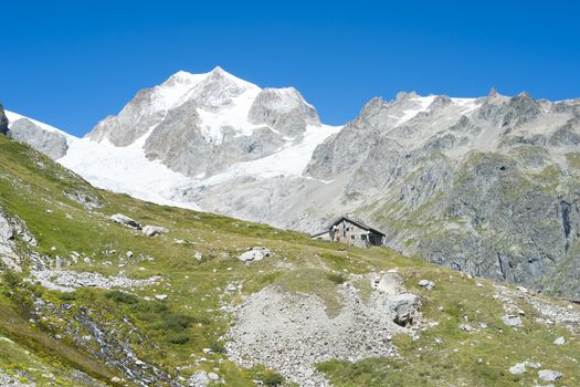 VAL VENY, ITALY - AUGUST 27: Elisabetta Soldini Refuge with Glaciers Needles in the background. The refuge is on a stage of the popular Mont Blanc tour. August 27, 2014 in Val Veny.