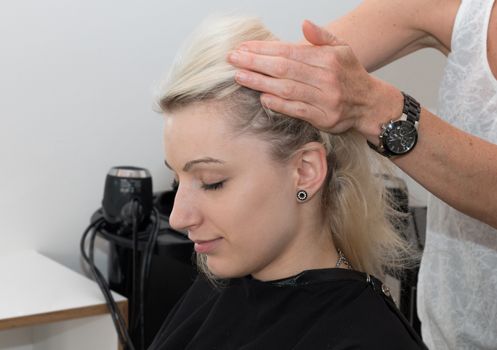 Blonde Girl Getting a Head Massage at a Hairdresser's Shop, relaxed face