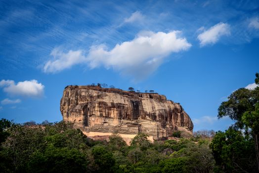 Sigiriya, known as the lion rock and the fortress in the sky. Located in the central Matale district near the town of Dambulla in the Central Province, Sri Lanka. The name refers to a site of historical and archaeological significance that is dominated by a massive column of rock nearly 200m high. According to the ancient Sri Lankan chronicle, the Culavangsha, this site was selected by King Kasyapa (477 – 495 CE) for his new capital. He built his palace on the top of this rock and decorated its sides with colourful frescoes.

Sigiriya is a UNESCO listed world heritage site. It is the best preserved examples of ancient urban planning and the most visited historic site in Sri Lanka.

Photographed using Nikon-D800E DSLR with AF-S NIKKOR 24-70 mm f/2.8G ED lens at focal length 42 mm and ISO 100.