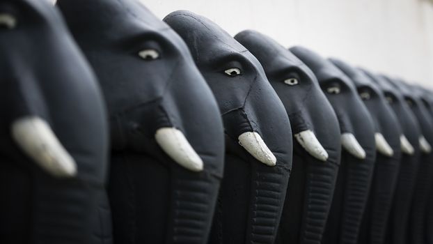 A row of frontline elephants sculptures at the temple.

Photographed using Nikon-D800E (36 megapixels) DSLR with AF-S NIKKOR 70-200 mm f/2.8G ED VR II lens at focal length 122 mm, ISO 100, and exposure 1/250 sec at f/2.8.