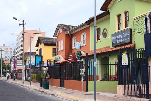 QUITO, ECUADOR - AUGUST 6, 2014: Unidentified people on Mariscal Foch Street in the tourist district with the hostels Discovery Quito and Piamonte along the road on August 6, 2014 in Quito, Ecuador. Around the streets Mariscal Foch and Reina Victoria are many hostels, bars and restaurants.