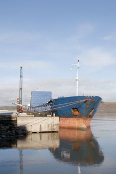 large ship being loaded with steel by crane at Youghal pier county Cork, Ireland