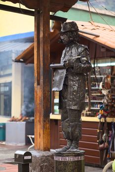 BANOS, ECUADOR - FEBRUARY 22, 2014: Unidentified person standing as a living statue posing as a poet at the Pasaje Artesanal (Artisan Passage) on February 22, 2014 in Banos, Ecuador. 