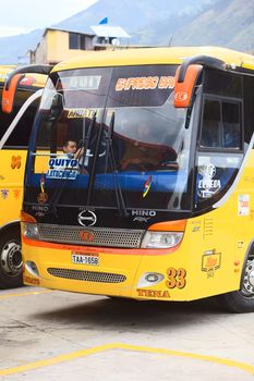 BANOS, ECUADOR - FEBRUARY 22, 2014: Unidentified people in a bus of the Expreso Banos transportation company in the bus terminal on February 22, 2014 in Banos, Ecuador. 