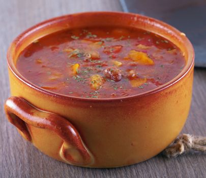 Soup with beans, tomato and bread in crock pot