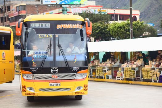 BANOS, ECUADOR - FEBRUARY 22, 2014: Bus of the Expreso Banos transportation company leaving the bus terminal on February 22, 2014 in Banos, Ecuador. 
