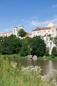 The Benedictine Abbey in Tyniec in Poland with wisla river on blue sky background