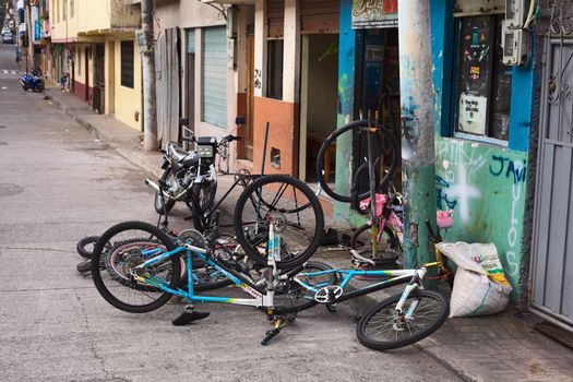 BANOS, ECUADOR - AUGUST 1, 2014: Bicycles in front of a bike repair shop on Juan Leon Mera street on August 1, 2014 in Banos, Ecuador. Banos is a small touristy town in Tungurahua Province in Central Ecuador. 