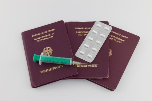 Disease Control: German passports with syringe and tablets
