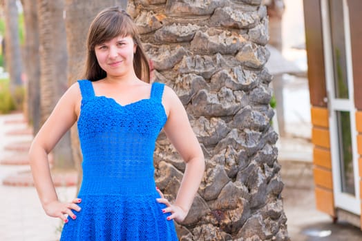 happy beautiful girl 20 years old in a blue sundress