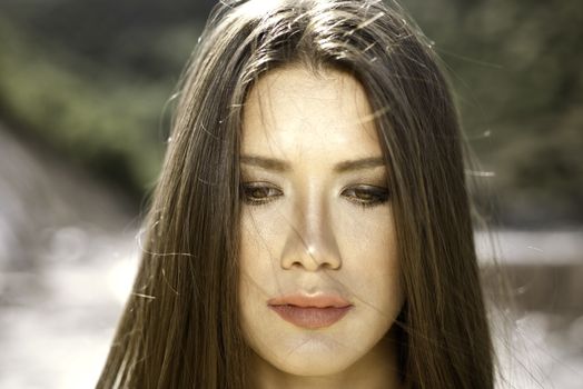 Close headshot portrait of a brown eye girl with golden light