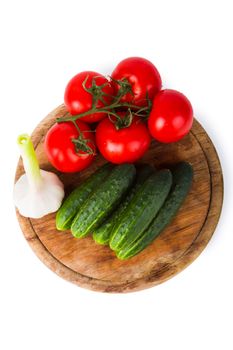 Cucumbers, tomatoes and garlic isolated on white