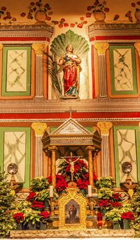 Old Mission Santa Ines Basilica Altar Cross Agnes Statue Solvang California at Christmas.  Founded in 1804, 19 of 21 Missions in California.  Named for Saint Agnes, young Roman girl martyr, symbol of purity and chastity.