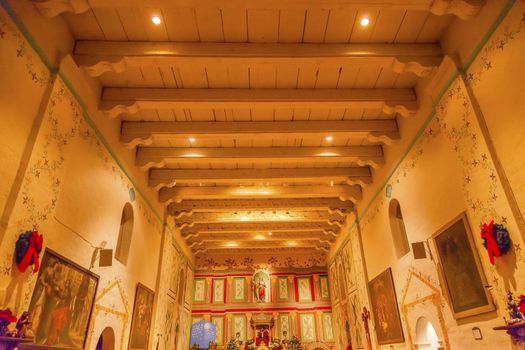 Old Mission Santa Ines Basilica Altar Cross Solvang California at Christmas.  Founded in 1804, 19 of 21 Missions in California.  Named for Saint Agnes, young Roman girl martyr, symbol of purity and chastity.