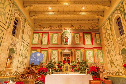 Old Mission Santa Ines Basilica Altar Cross Agnes Statue Solvang California at Christmas.  Founded in 1804, 19 of 21 Missions in California.  Named for Saint Agnes, young Roman girl martyr, symbol of purity and chastity.