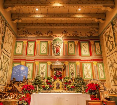 Old Mission Santa Ines Basilica Altar Cross Agnes Statue Solvang California at Christmas.  Founded in 1804, 19 of 21 Missions in California.  Named for Saint Agnes, young Roman girl martyr, symbol of purity and chastity.