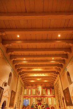 Old Mission Santa Ines Basilica Altar Cross Solvang California at Christmas.  Founded in 1804, 19 of 21 Missions in California.  Named for Saint Agnes, young Roman girl martyr, symbol of purity and chastity.