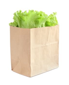 Grocery bag with green lettuce salad isolated on white background