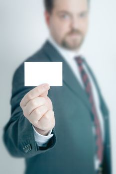 An image of a business man holding a card