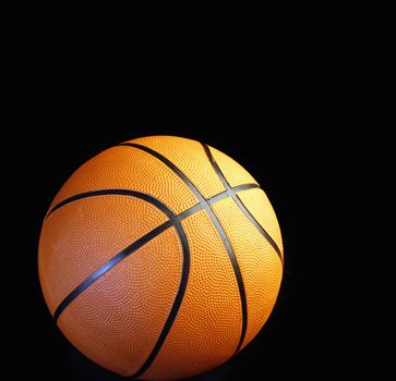 One basketball on black background 