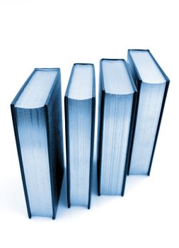 Four books on plain background