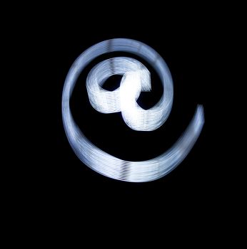 At and e-mail Symbol Icon Using Light Painting Technique isolated over black Background