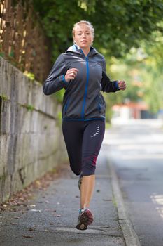 Pretty young girl runner.  Running woman. Female Runner Jogging during Outdoor Workout. Beautiful fit Girl. Fitness model outdoors. Weight Loss. Healthy lifestyle. 