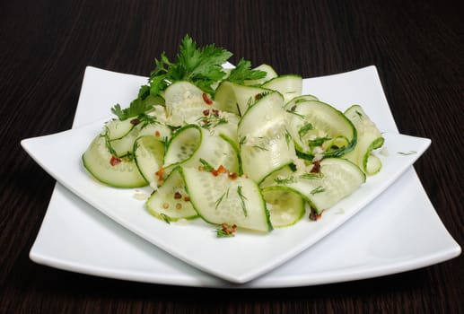 Acute appetizer of fresh cucumbers with garlic, dill, spices