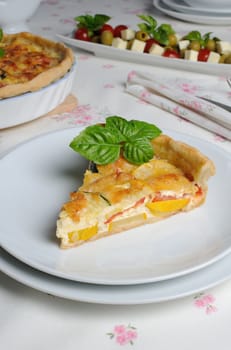 Quiche with zucchini (green, yellow) and tomatoes baked cheese