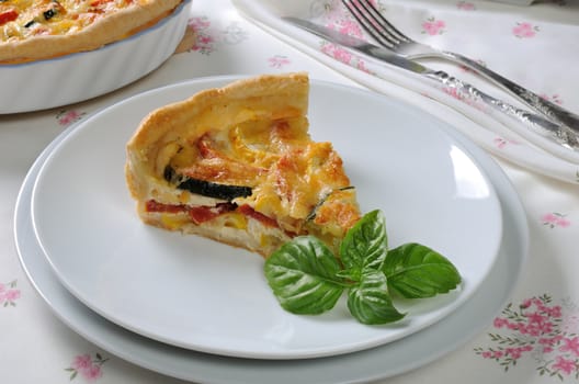 Quiche with zucchini (green, yellow) and tomatoes baked cheese