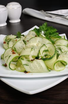 Acute appetizer of fresh cucumbers with garlic, dill, spices