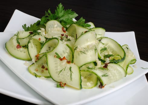 Acute appetizer of fresh cucumbers with garlic, dill, spices