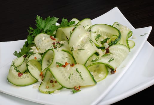 Acute appetizer of fresh cucumbers with garlic, dill, spices