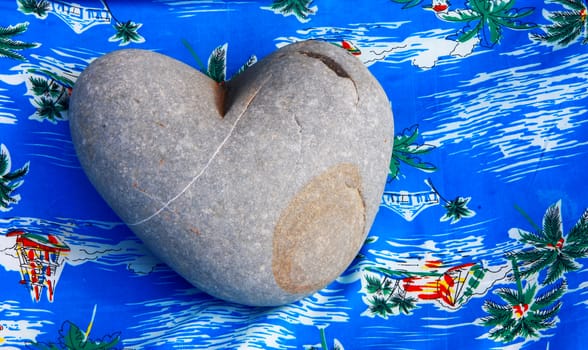 Heart of stone and blue background with palms