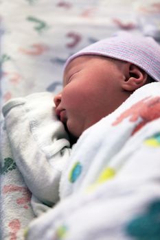 Sleeping newborn baby in hospital. The first hours of life of the newborn girl