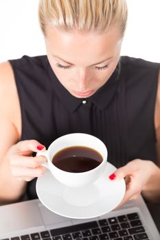 Business woman holding white cup of coffee in her hands. Coffee break.