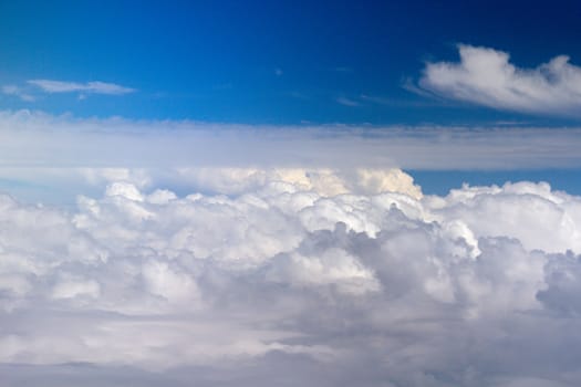 Photo shows details of white clouds and blue sky.