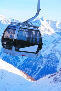 Ski lift chairs on bright winter day in Alp mountains