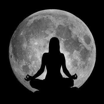 Yoga lotus position silhouette against the full Moon