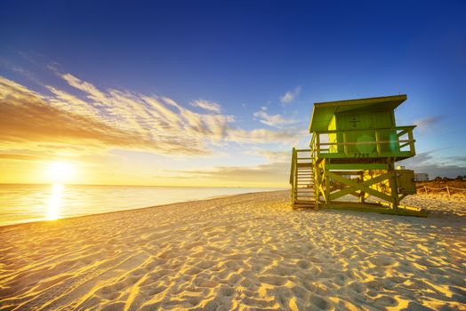 Miami South Beach sunrise with lifeguard tower and coastline with colorful cloud and blue sky. 